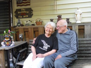 The Steinkes pose under a hand-carved wooden sign with the date they moved in to Edgewater.  Credit: Karen Chen
